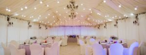Wedding tent decorated with chandelier amd fairy lights