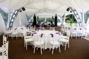 Interior of a event tent with event rentals decoration ready for guests.
