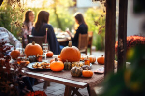Family having a meal outdoors, table setting on Halloween