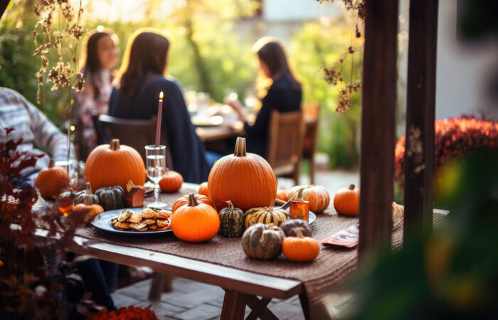 Family having a meal outdoors, table setting on Halloween