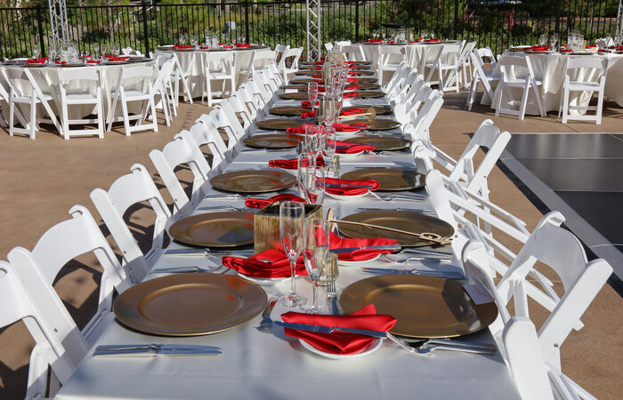 Long party rental tables and chairs at an outdoor venue